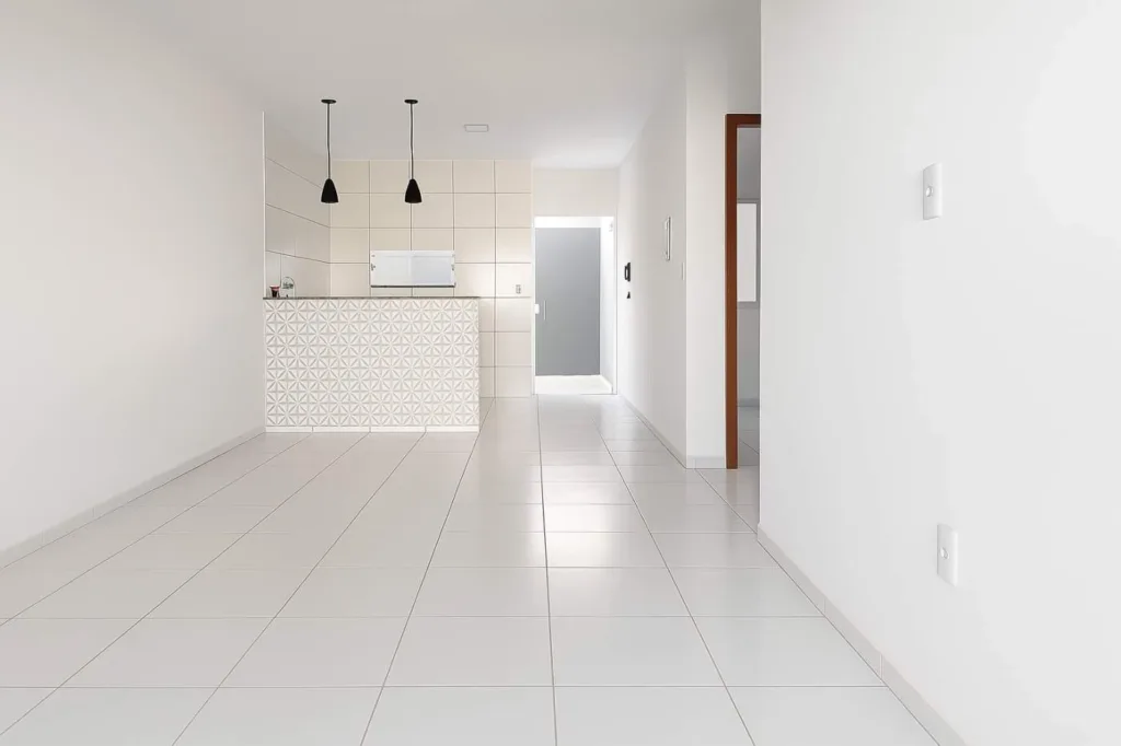 Sala da casa em Campo Alegre integrada à cozinha com bancada e iluminação pendente